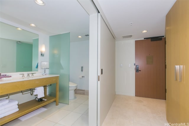 bathroom featuring vanity, toilet, and tile patterned flooring