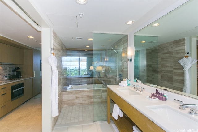 bathroom with vanity, plus walk in shower, tile walls, and tile patterned flooring