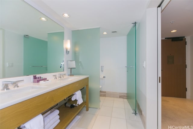 bathroom featuring vanity, toilet, and tile patterned flooring