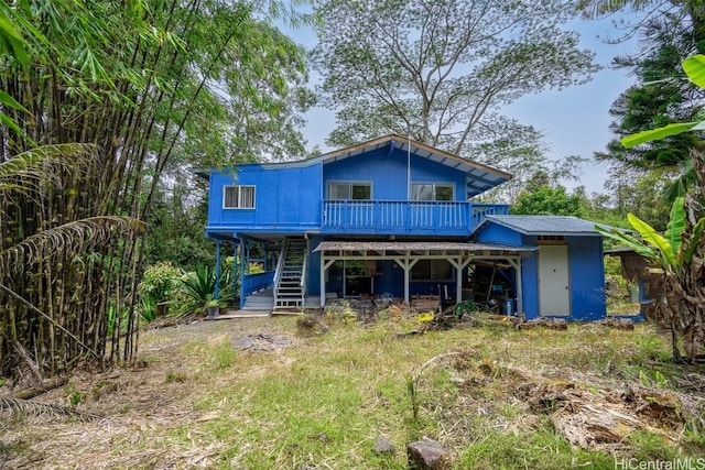 back of property featuring a wooden deck