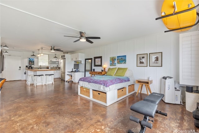 bedroom featuring ceiling fan and stainless steel fridge