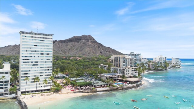 aerial view featuring a water and mountain view and a beach view