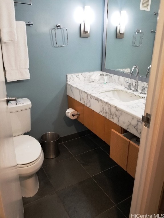 bathroom featuring vanity, toilet, and tile patterned floors