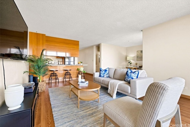 living room with hardwood / wood-style flooring and a textured ceiling