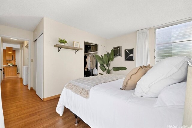 bedroom with a closet and light hardwood / wood-style flooring