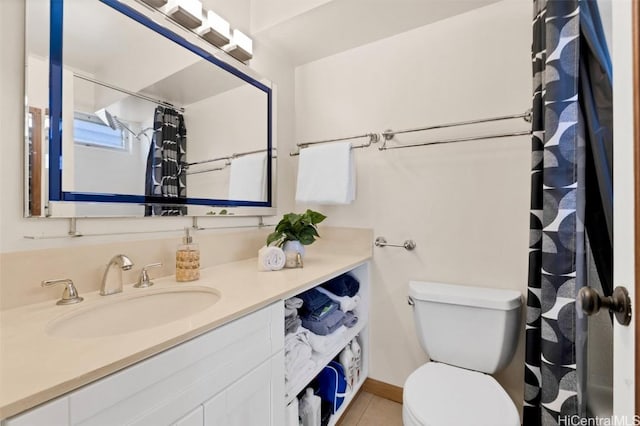 bathroom featuring tile patterned flooring, vanity, and toilet