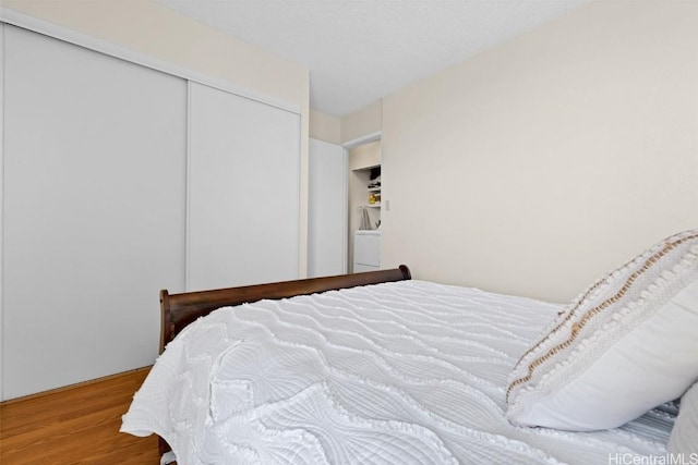 bedroom with hardwood / wood-style floors and a closet