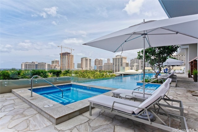 view of swimming pool with a community hot tub and a patio area