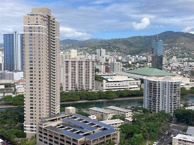 property's view of city with a water and mountain view