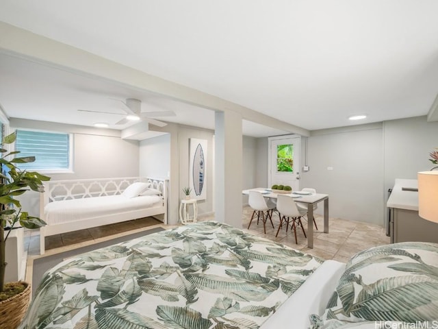 bedroom with ceiling fan, multiple windows, and light tile patterned floors