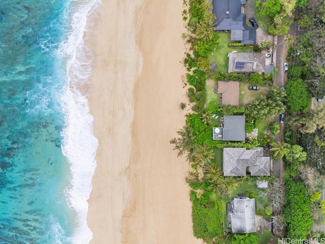 bird's eye view with a water view and a beach view