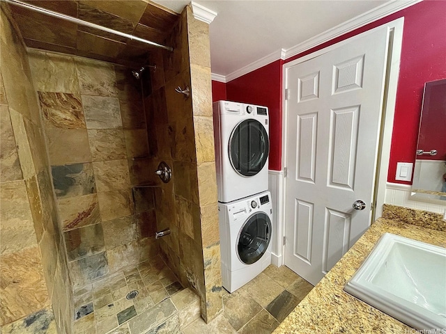 2215 Aloha Dr Unit 701, Honolulu, HI 96815 - laundry area featuring stacked washing machine and dryer, ornamental molding, and stone finish flooring