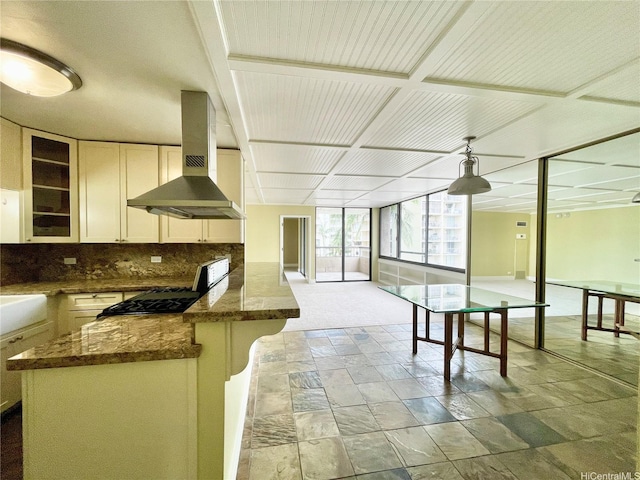 2215 Aloha Dr Unit 701, Honolulu, HI 96815 - kitchen featuring extractor fan, stone tile flooring, tasteful backsplash, glass insert cabinets, and a peninsula