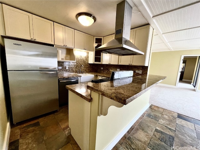 kitchen with tasteful backsplash, appliances with stainless steel finishes, a breakfast bar, island range hood, and dark stone countertops