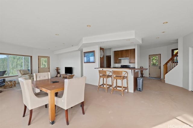 dining area featuring stairway, recessed lighting, and finished concrete flooring