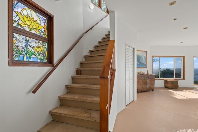 stairs featuring concrete floors