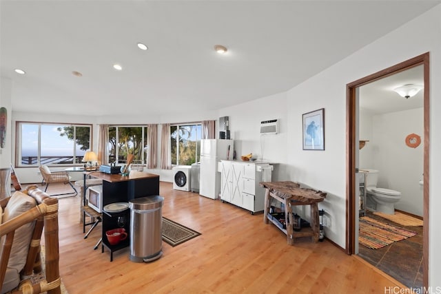 interior space featuring recessed lighting, an AC wall unit, light wood-style floors, and a healthy amount of sunlight