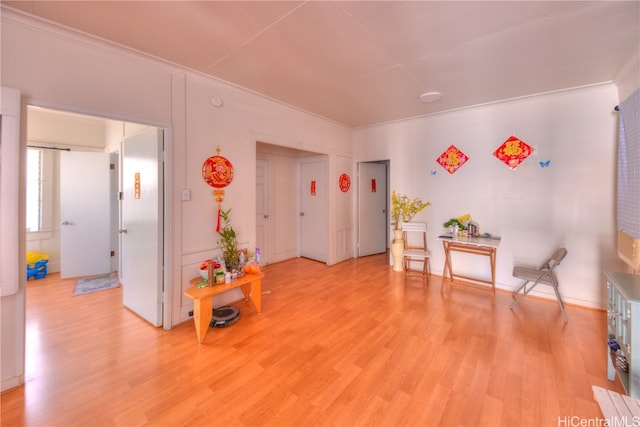 misc room featuring light hardwood / wood-style floors and crown molding