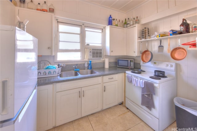 kitchen with sink, white cabinets, white appliances, and light tile patterned floors