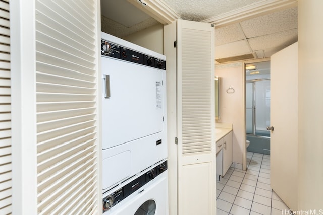 washroom featuring stacked washer / dryer and light tile patterned floors