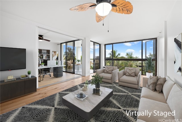 living room with hardwood / wood-style floors, ceiling fan, and expansive windows