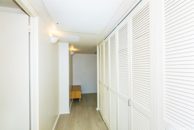 corridor with light hardwood / wood-style flooring