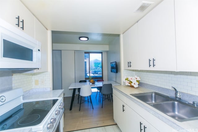 kitchen with white appliances and white cabinetry