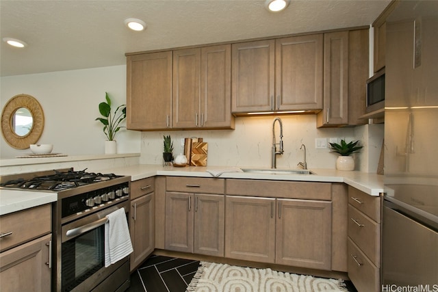 kitchen with appliances with stainless steel finishes, sink, and kitchen peninsula