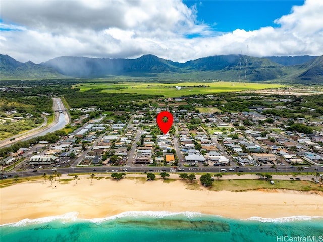 birds eye view of property with a view of the beach and a water and mountain view