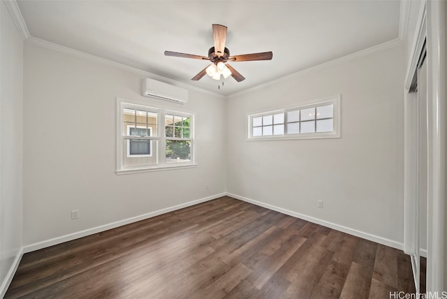 spare room with ornamental molding, dark wood-type flooring, a wall unit AC, and ceiling fan