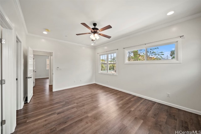 spare room with crown molding, dark wood-type flooring, and ceiling fan