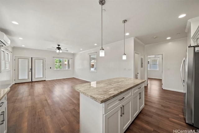 kitchen featuring dark hardwood / wood-style flooring, white cabinets, pendant lighting, and stainless steel refrigerator