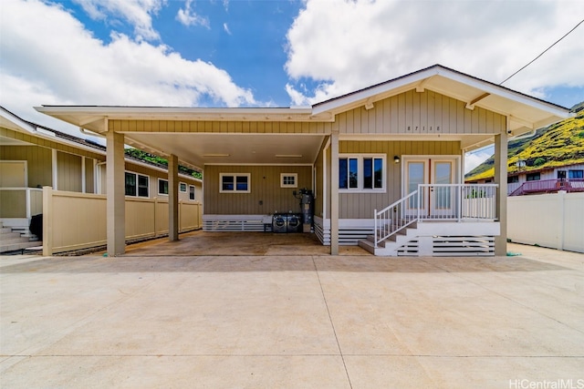 back of property with a carport