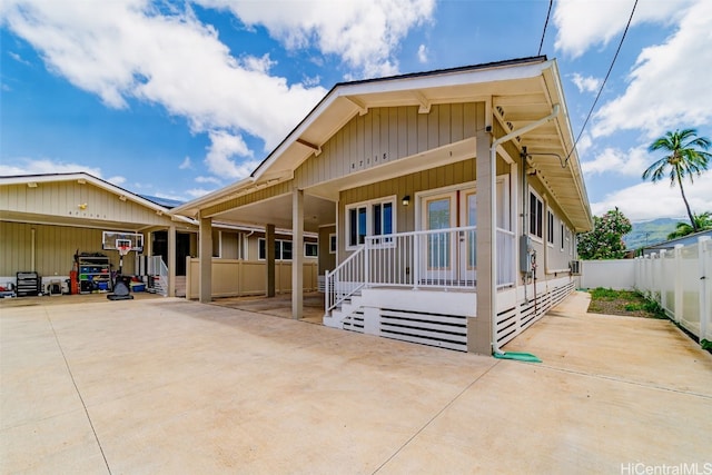 view of front of property featuring an AC wall unit and covered porch