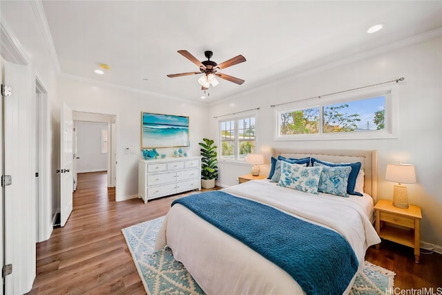 bedroom with ceiling fan, ornamental molding, and hardwood / wood-style floors