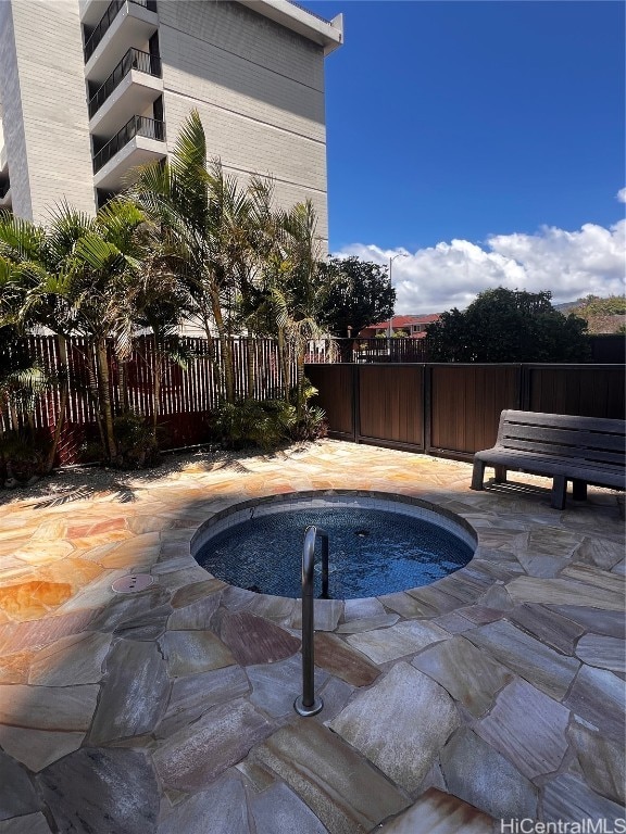 view of pool with a jacuzzi and a patio area