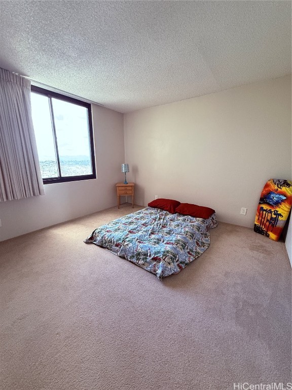 carpeted bedroom with a textured ceiling