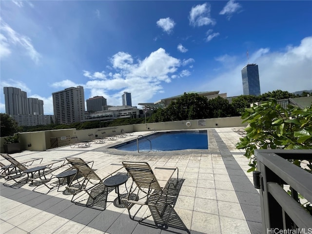 view of swimming pool with a patio