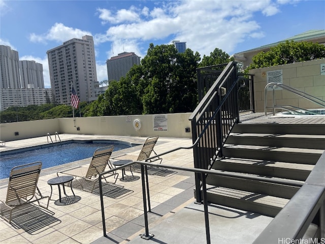 view of swimming pool with a patio