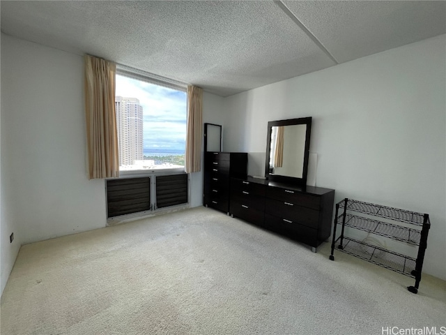 carpeted bedroom with a textured ceiling