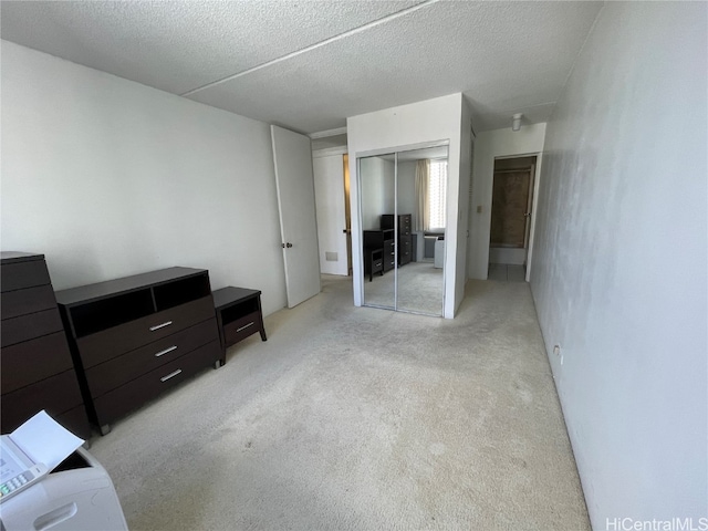 carpeted bedroom with a closet and a textured ceiling