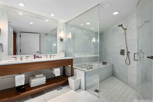 bathroom featuring vanity, tile walls, shower with separate bathtub, and tile patterned flooring