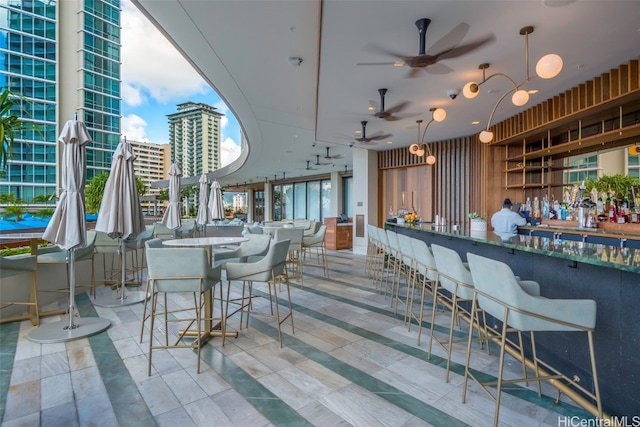 view of patio featuring an outdoor bar and ceiling fan