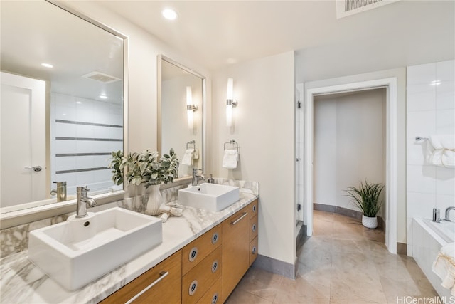 bathroom featuring vanity, a bathtub, and tile patterned flooring