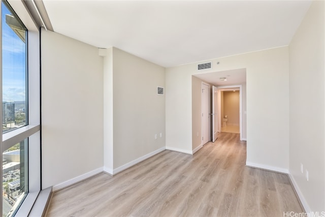 spare room featuring light hardwood / wood-style floors