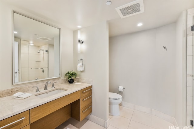 bathroom featuring vanity, toilet, tile patterned floors, and a shower with door