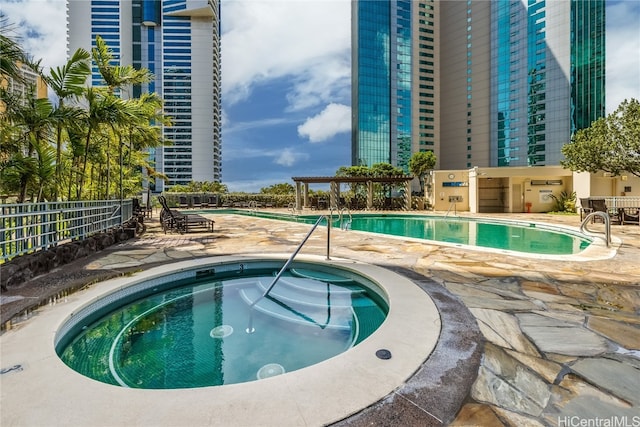 view of pool with a patio area and a community hot tub