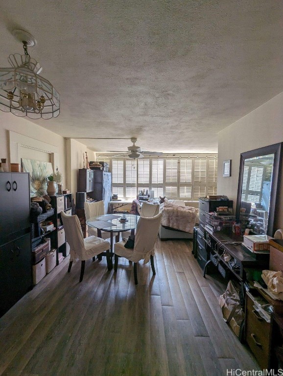 dining room featuring a textured ceiling, hardwood / wood-style flooring, and ceiling fan