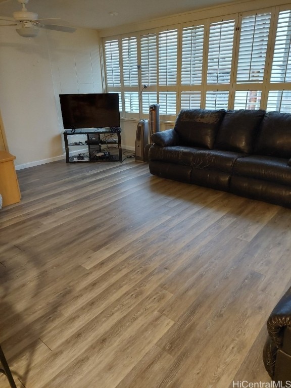 living room featuring hardwood / wood-style flooring and ceiling fan