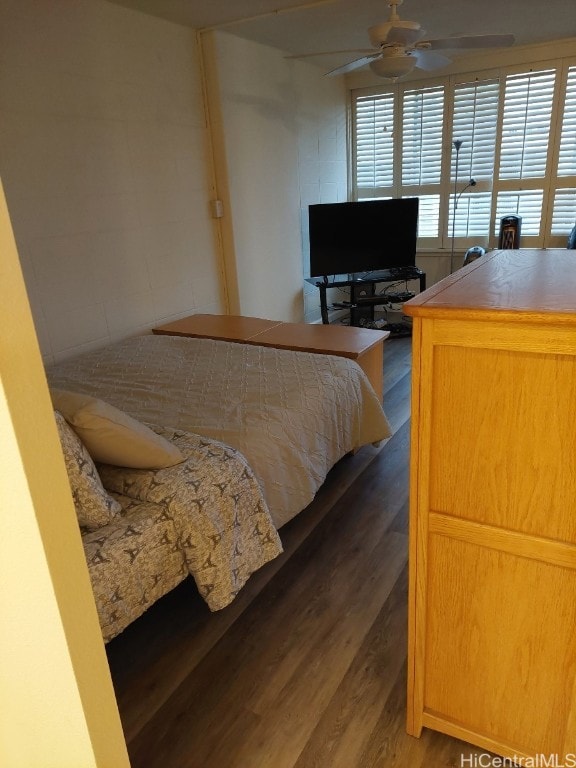 bedroom with dark wood-type flooring and ceiling fan